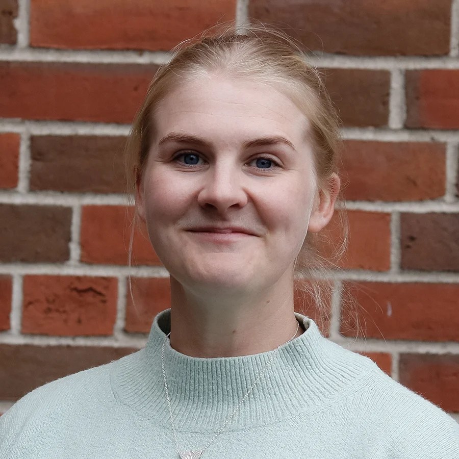 a woman with blond hair, smiling